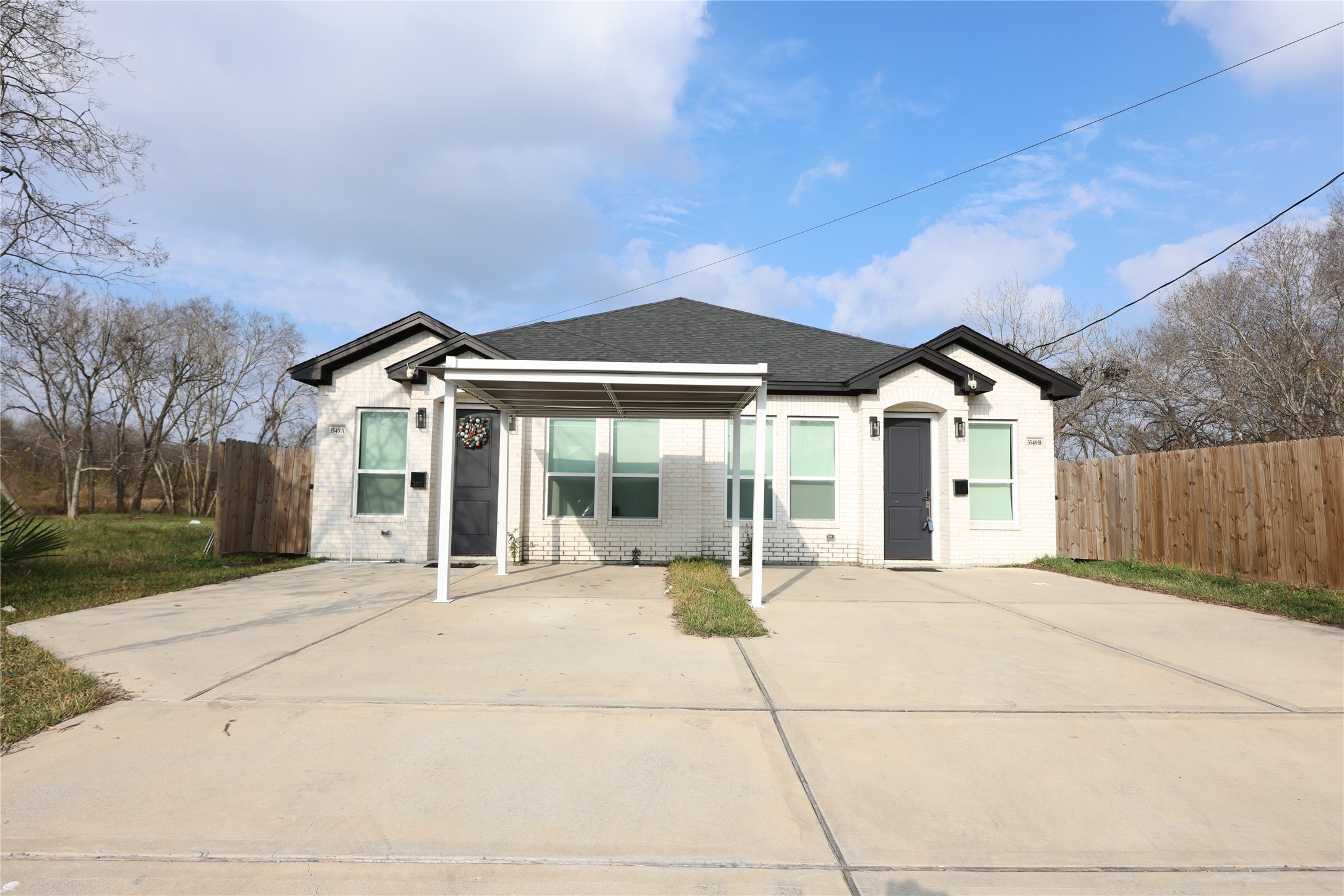 3549 Amos Street Houston, TX 77021 - Photo 1 of 19 a patio with a table and chairs under an umbrella