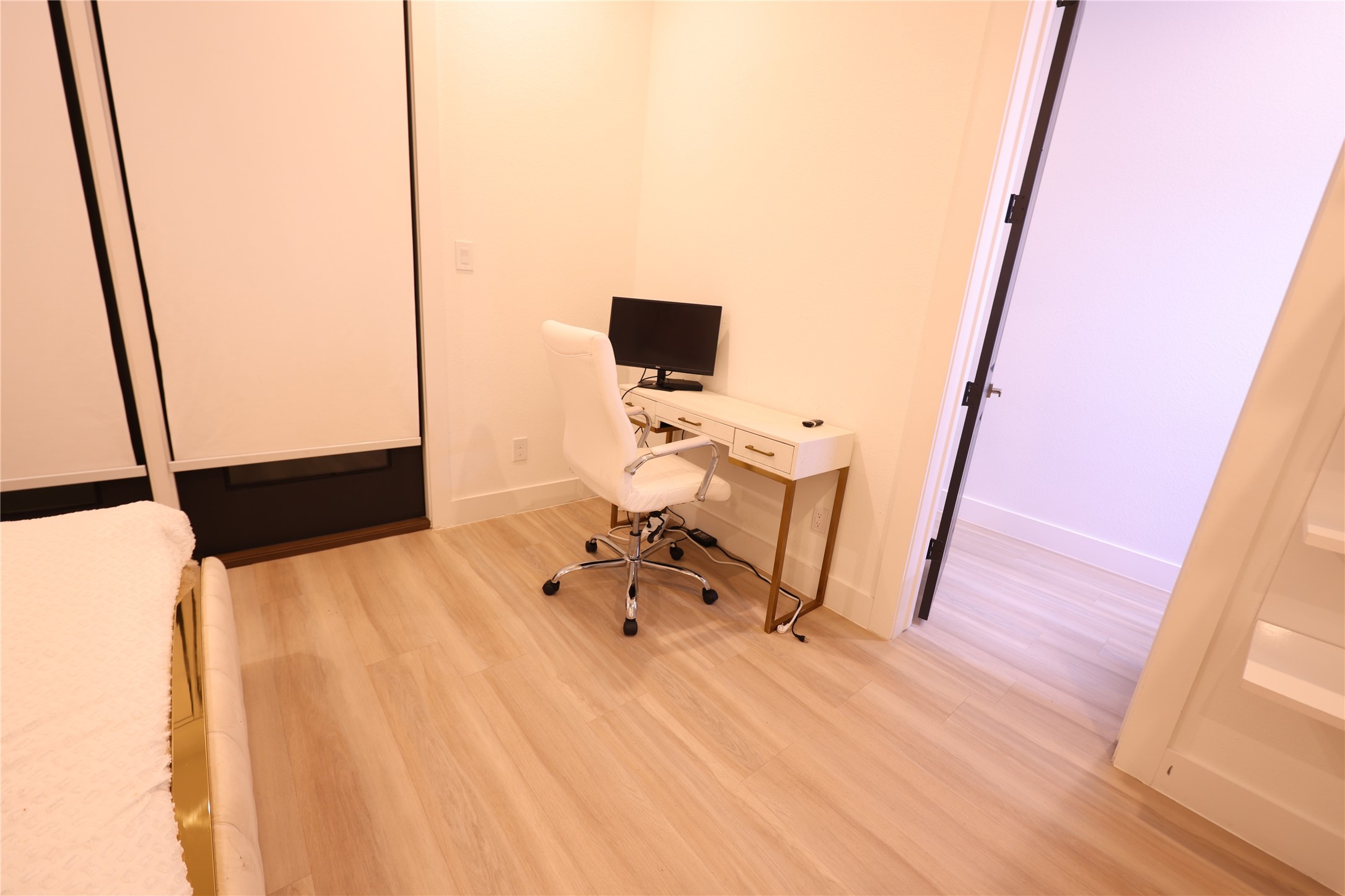 3549 Amos Street Houston, TX 77021 - Photo 17 of 19 a bedroom with a bed and a flat tv screen on a dresser
