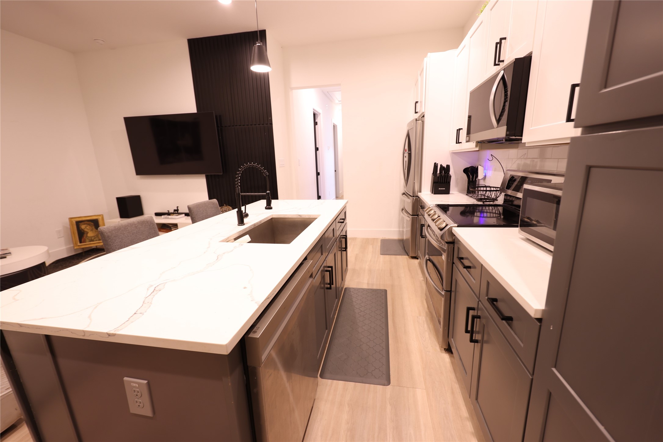 3549 Amos Street Houston, TX 77021 - Photo 9 of 19 a kitchen with a sink and a stove top oven with wooden floor