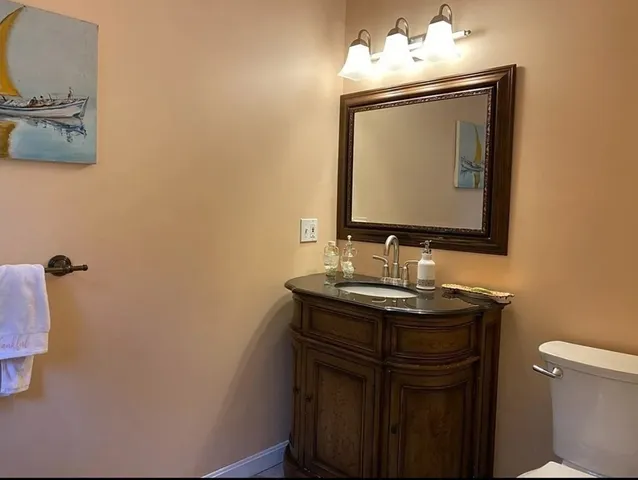 a bathroom with a toilet sink and mirror