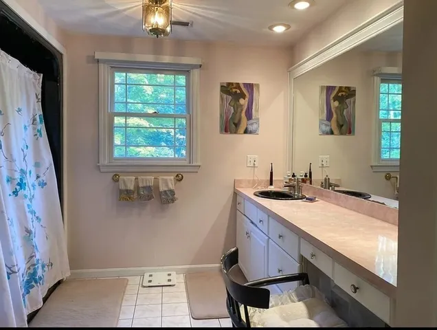 a room with a sink and a mirror