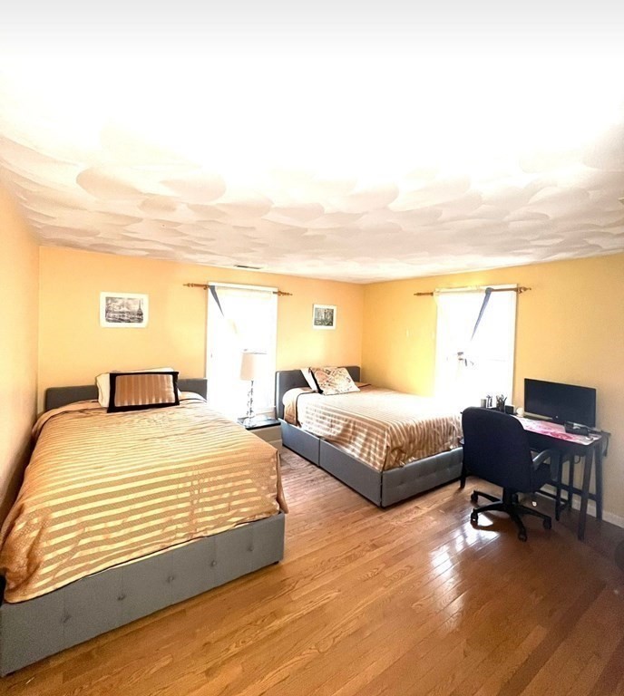 338 River Road Andover, MA 01810 - Photo 17 of 28 a spacious bedroom with a bed and chair
