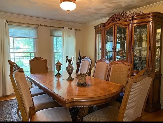 a dining room with furniture and window