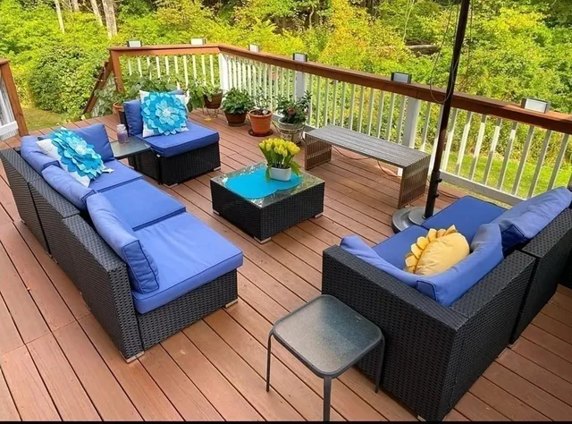 a outdoor sitting area with furniture and wooden deck
