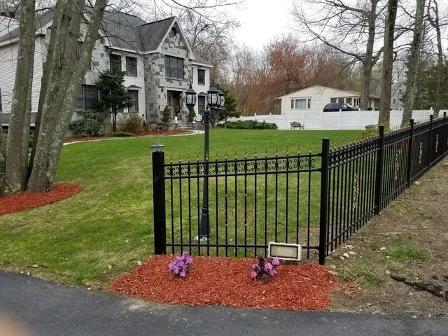 a view of a park with iron fence