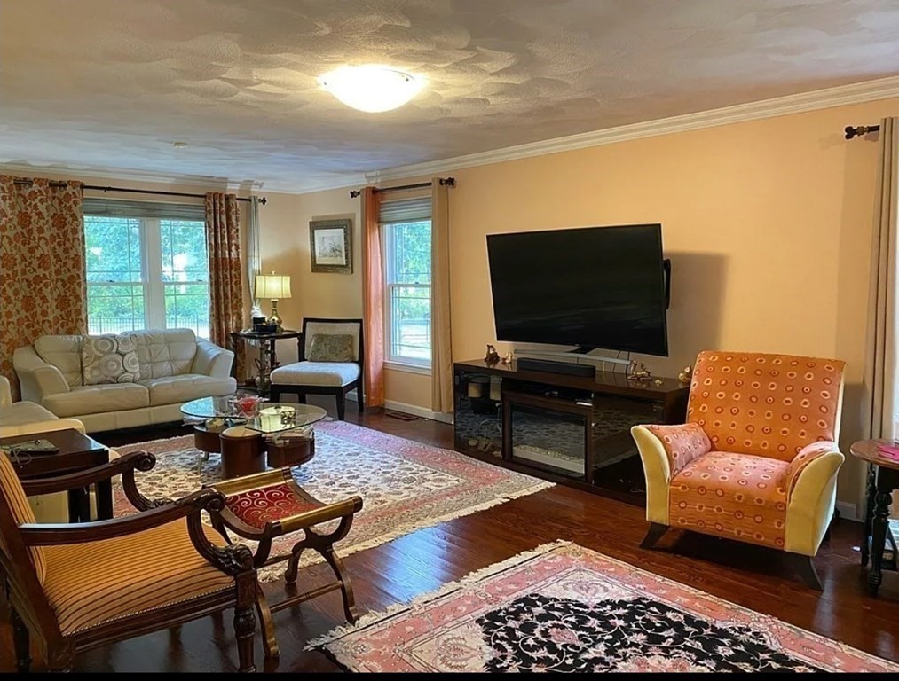 338 River Road Andover, MA 01810 - Photo 4 of 28 a living room with furniture and a flat screen tv