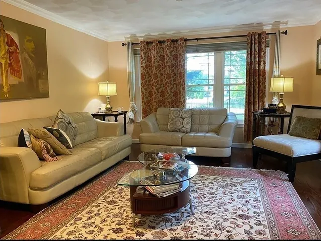 a living room with furniture and a rug