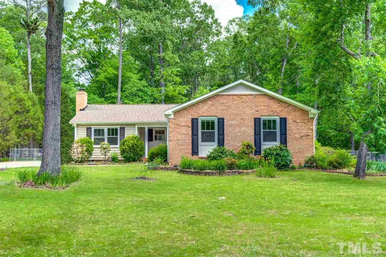 5907 Newhall Road Durham, NC 27713 - Photo 1 of 29 a front view of a house with a yard and green space