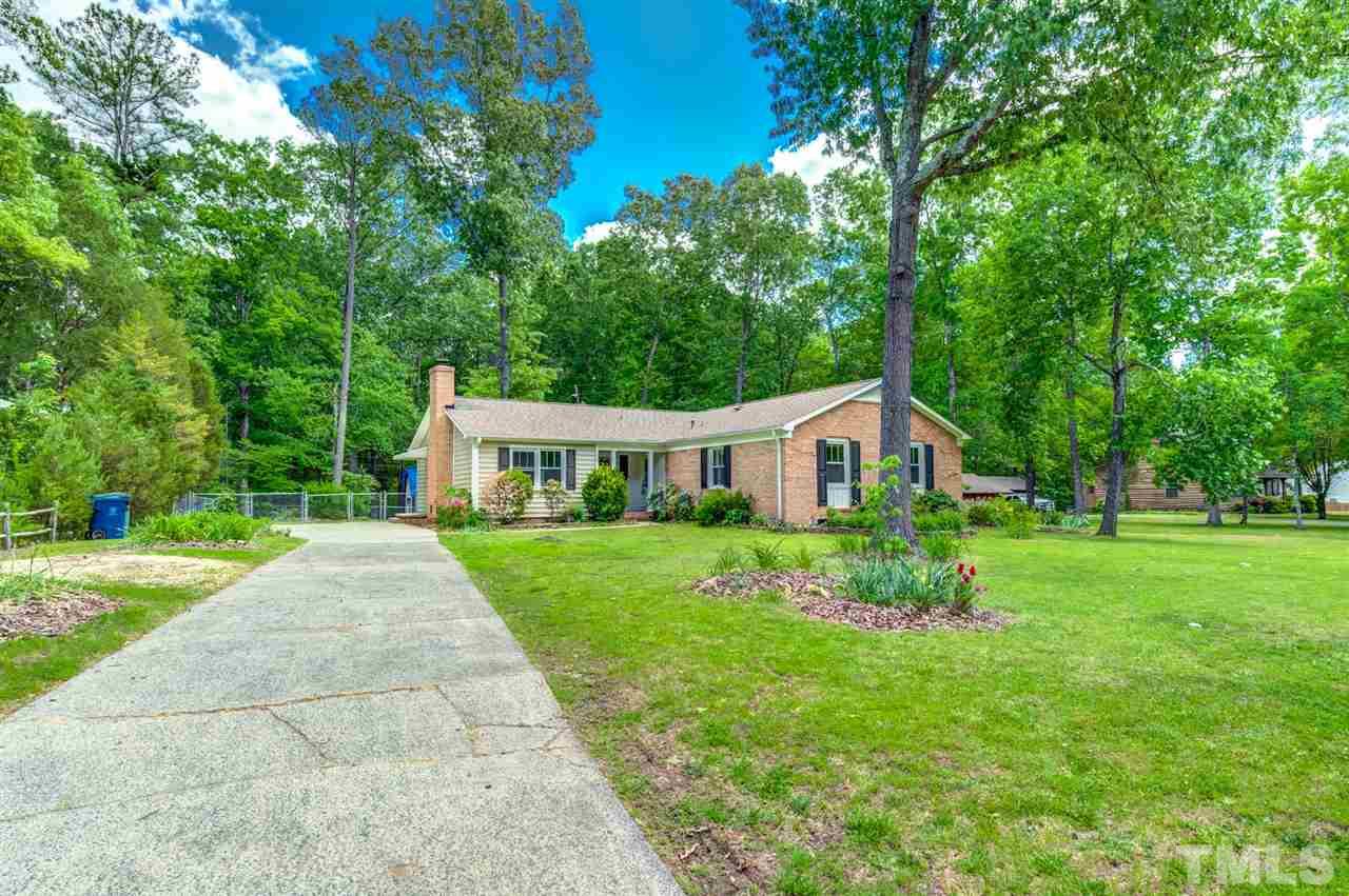 5907 Newhall Road Durham, NC 27713 - Photo 2 of 29 a front view of a house with a yard table and chairs