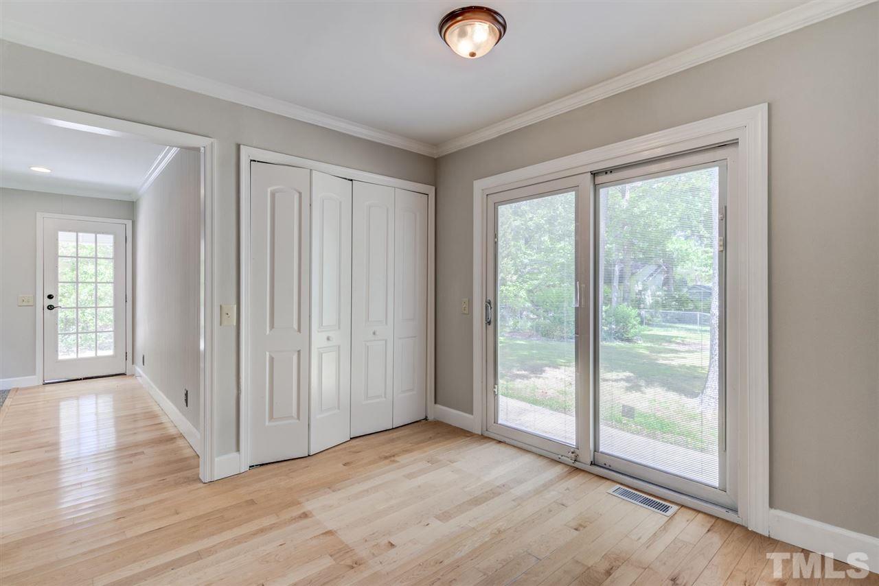 5907 Newhall Road Durham, NC 27713 - Photo 11 of 29 an empty room with wooden floor and windows