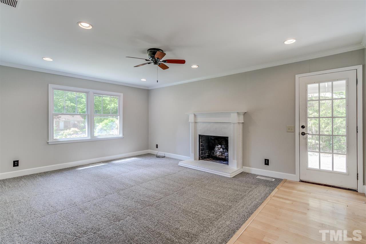 5907 Newhall Road Durham, NC 27713 - Photo 12 of 29 a view of an empty room with a window and a fireplace