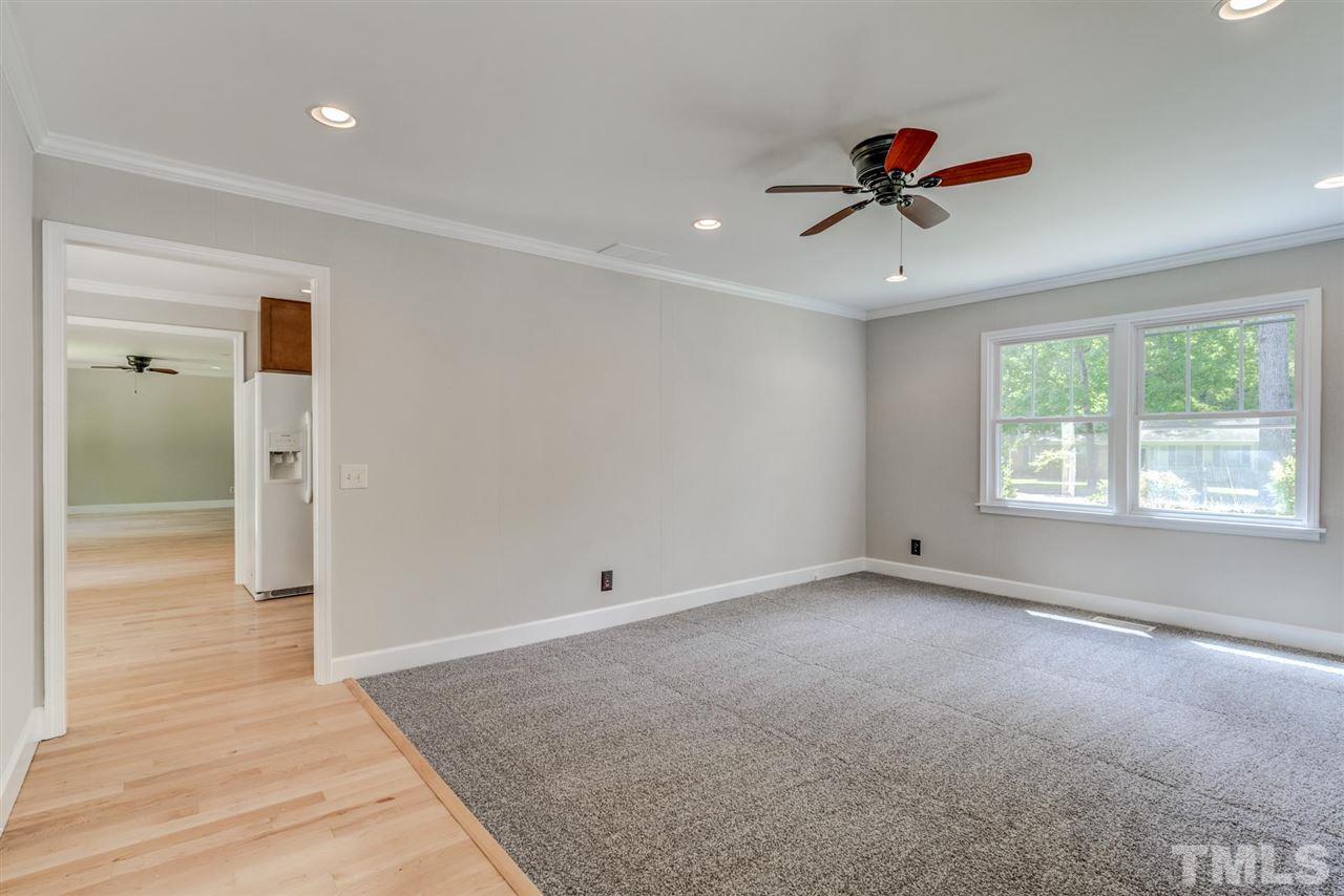 5907 Newhall Road Durham, NC 27713 - Photo 13 of 29 wooden floor in an empty room with a window
