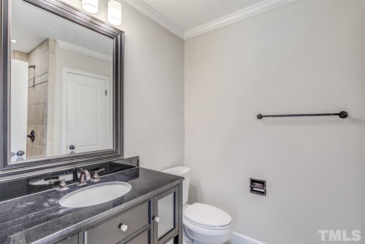 5907 Newhall Road Durham, NC 27713 - Photo 15 of 29 a bathroom with a granite countertop sink mirror vanity and toilet
