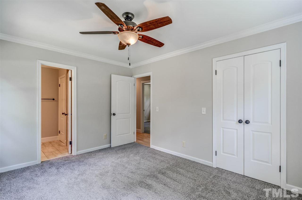 5907 Newhall Road Durham, NC 27713 - Photo 18 of 29 an empty room with closet and a chandelier fan