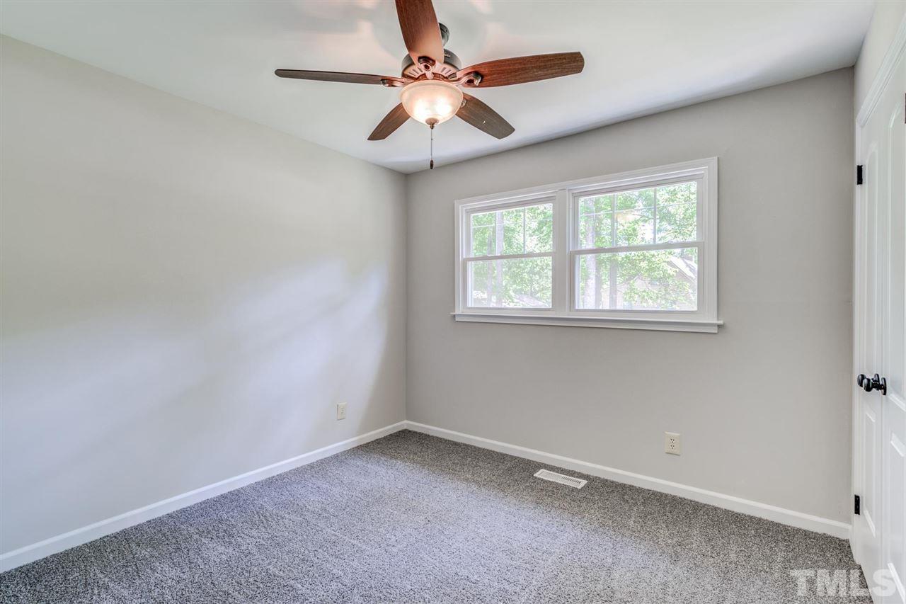 5907 Newhall Road Durham, NC 27713 - Photo 21 of 29 an empty room with a window and a fan