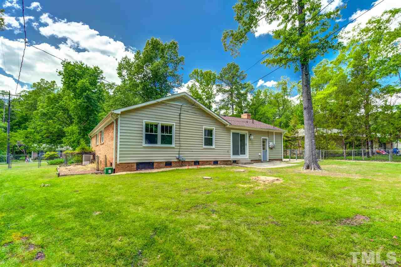 5907 Newhall Road Durham, NC 27713 - Photo 23 of 29 a backyard of a house with table and chairs