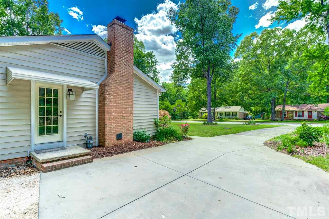 5907 Newhall Road Durham, NC 27713 - Photo 4 of 29 a front view of a house with garden