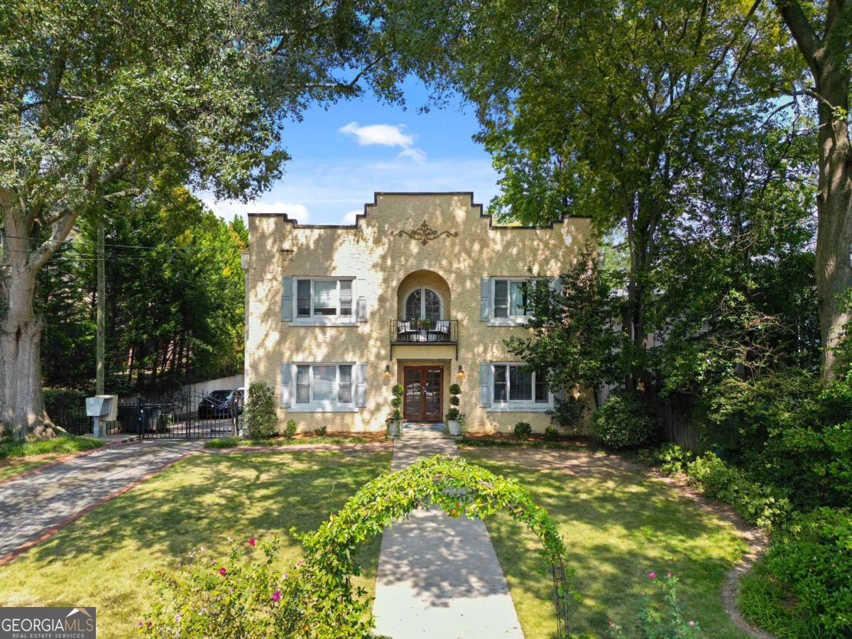 a view of swimming pool with a garden and plants