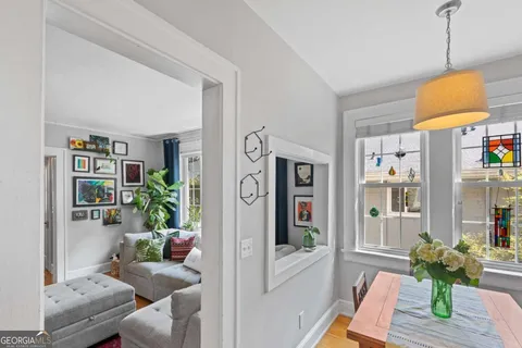 a vase of flowers sitting on a table with wooden floor