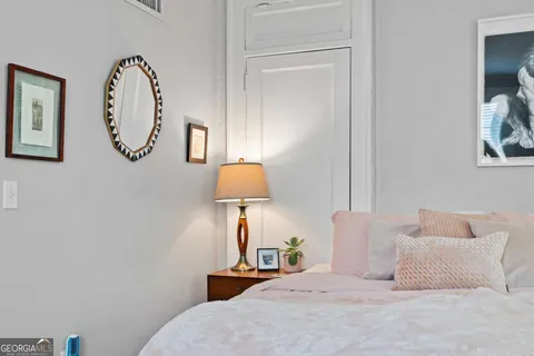 a bed sitting in a bedroom next to a window