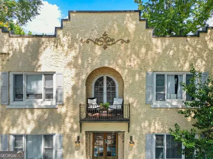 a front view of a building with a garden