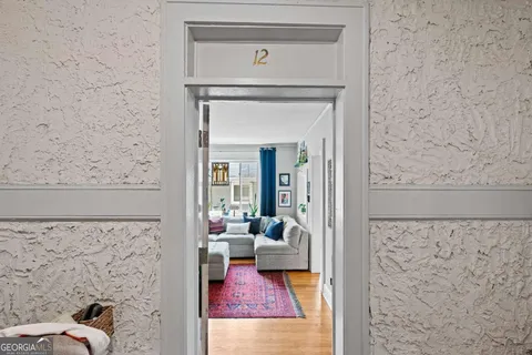 a view of a bedroom with wooden floor and a fireplace