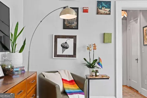 a living room with furniture and a potted plant