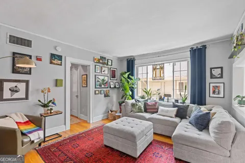 a living room with furniture and a rug