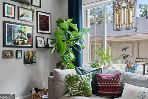 a living room filled with furniture and a potted plant