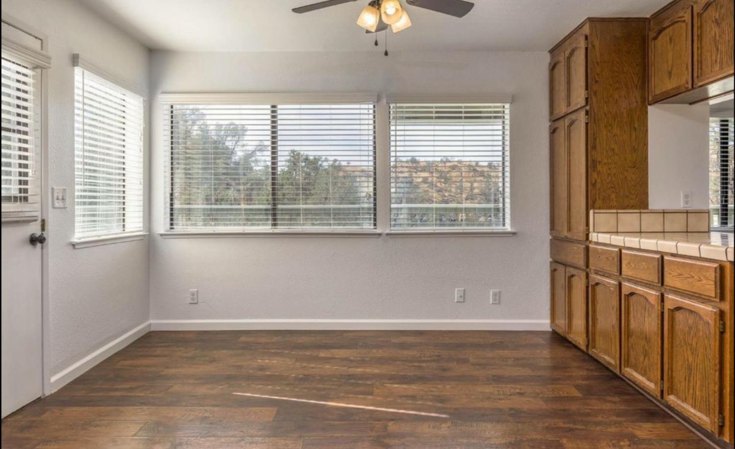 27817 Sky Harbour Road Friant, CA 93626 - Photo 11 of 36 a view of a kitchen with an empty space and a window