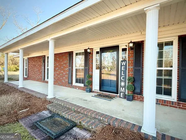 a view of a house with snow on the road