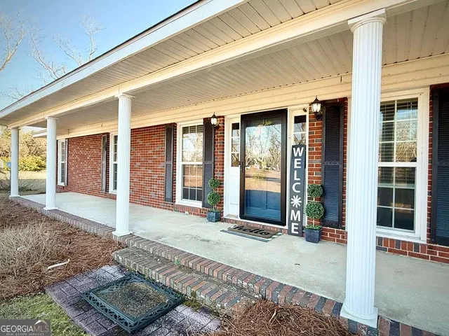 a view of a house with snow on the road