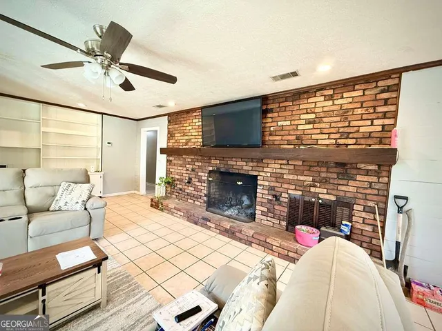 a living room with fireplace furniture and a flat screen tv