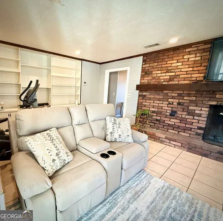 a living room with fireplace furniture and a flat screen tv