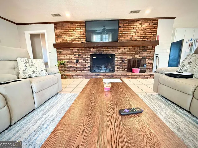 a kitchen with granite countertop a refrigerator and a stove top oven