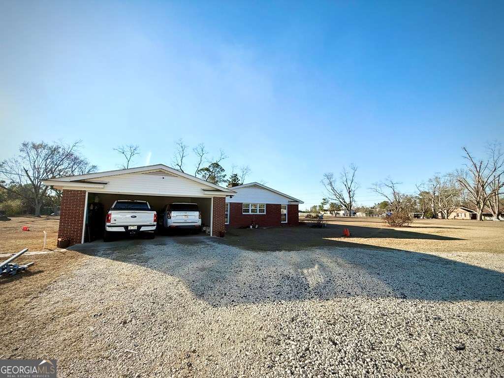 201 Burketts Ferry Road Hazlehurst, GA 31539 - Photo 6 of 52 a view of a house with a yard and sitting area