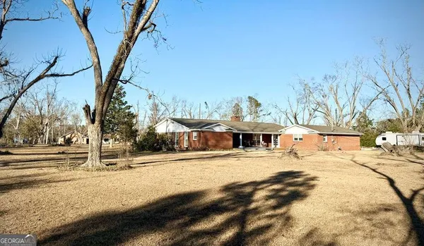 a view of a yard with large trees