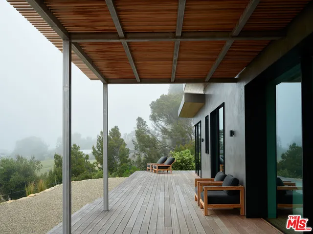 a bedroom with furniture and a flat screen tv