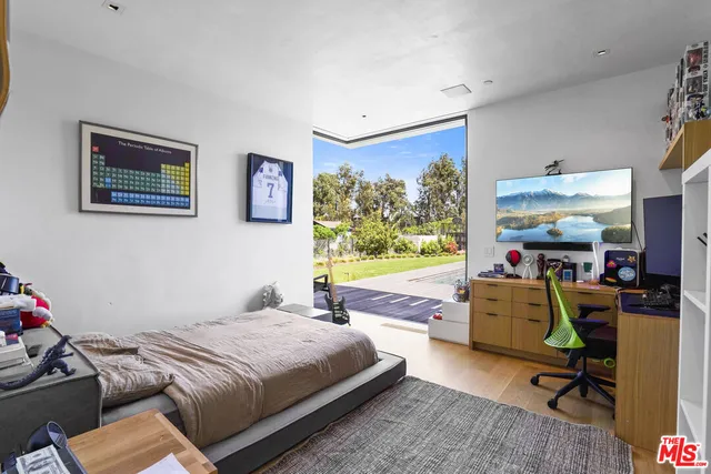a living room with fireplace furniture and a large window