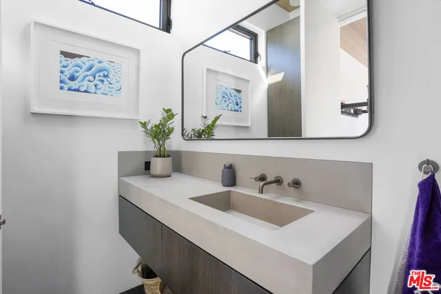 a living room with couch a flat screen tv and floor to ceiling window