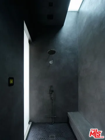 a bedroom with a large window and a bed