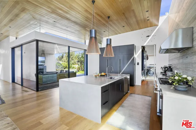 a living room with fireplace furniture and a large window