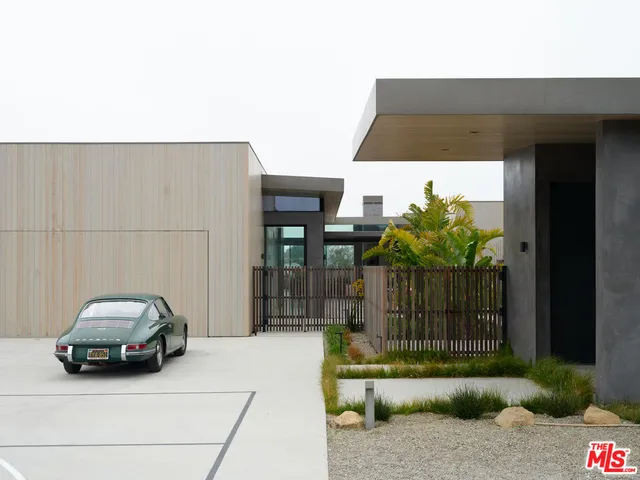 a bedroom with furniture and a large window