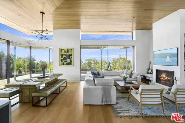 a view of living room with furniture and a floor to ceiling window