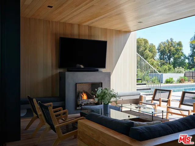 a view of a balcony with chairs and wooden floor