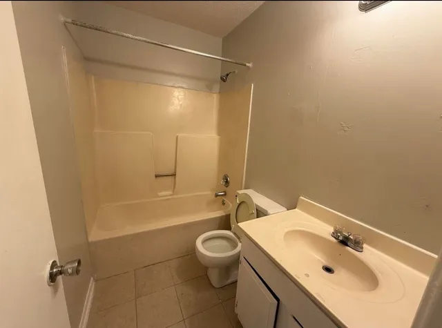 a bathroom with a sink mirror toilet and bathtub