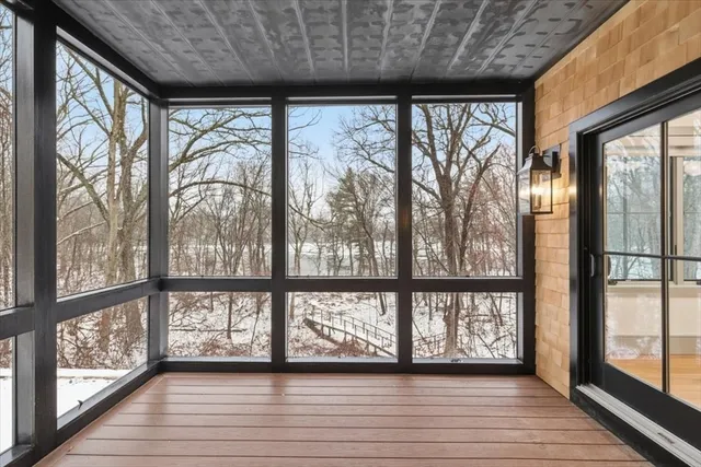 a view of hallway with wooden floor
