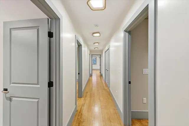 a view of empty room with wooden floor