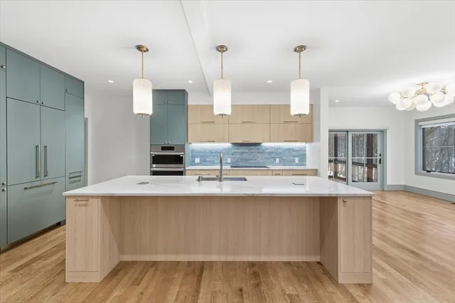 a kitchen with kitchen island a counter top space appliances and cabinets