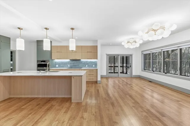 a view of a kitchen with wooden floor and a kitchen